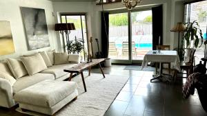 a living room with a couch and a table at Unikt boende i egen del av hus nära stad och strand in Ystad