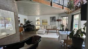 a living room with a couch and a table at Unikt boende i egen del av hus nära stad och strand in Ystad