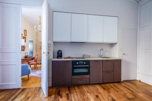 a kitchen with a sink and a stove at Appartement raffiné vue cathédrale, jardin, wifi in Tours +25 photos