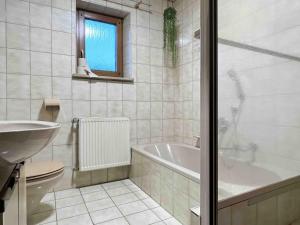 a white bathroom with a tub and a sink at SAD501 - Gemütliche Monteurwohnung in Schwandorf in Bayern