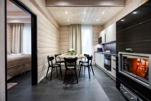 a kitchen and dining room with a table and chairs at Santa's Luxury Boutique Villa - Santa Claus Village in Rovaniemi +42 photos