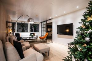 a living room with a christmas tree in it at Santa's Luxury City Apartment 1 in Rovaniemi