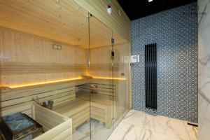 a sauna with a glass shower in a room at City Center - Amber Sky Apartments by Apartmore in Gdańsk