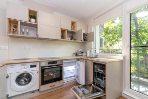 a kitchen with a washer and dryer and a window at Peaceful retreat - free parking in Plovdiv