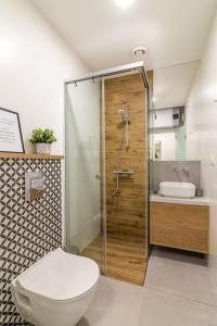 a bathroom with a shower and a toilet and a sink at Peaceful retreat - free parking in Plovdiv +45 photos