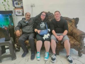 a group of three people sitting on a couch at hotel khubsaras palace by chhabra's in Agra