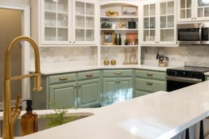 琼斯伯勒Sink into the Luxe Corner Tub at an Upscale, Spacious Home的厨房配有绿色橱柜和白色台面 更多29张照片