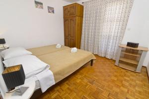Postel nebo postele na pokoji v ubytování Apartments Ive