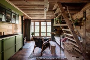 a living room with a spiral staircase in a house at Tjiftjaf in Retie