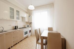 a kitchen with a table and chairs and a dining room at Apartment perfect amplasat! in Chişinău +4 photos