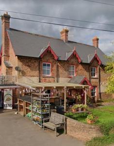 a brick building with a store in front of it at Church View, Poltimore Village - near Exeter in Exeter
