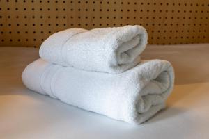 a stack of white towels sitting on a table at The Camden Town Hotel in London