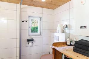 a bathroom with a shower and a wooden counter at Kastnhäusl Wildschönau Urige Hütte in Oberau