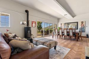 a living room with a couch and a table at Villa Blue Sky Cape Town in Cape Town