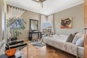 a bedroom with a bed and a living room at Villa Blue Sky Cape Town in Cape Town