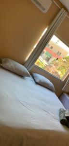 a bedroom with a large bed with a window at Pousada Licuri in Ibicoara