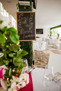 a table with a sign in the middle of a restaurant at Riviera 990 - Resort & Restaurant in Eşelniţa