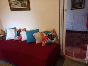 a group of pillows sitting on top of a bed at Casa térrea in Paraty +28 photos