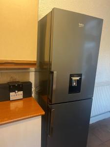 a stainless steel refrigerator sitting in a kitchen at Balfour House in Leicester +32 photos