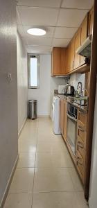 Una pequeña cocina con estufa y refrigerador. en Edifico Orbiplaya, en Torrevieja 17 fotos más