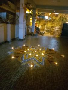 a snowflake with lights on the floor in a room at Sri sinampalli resedence in Visakhapatnam
