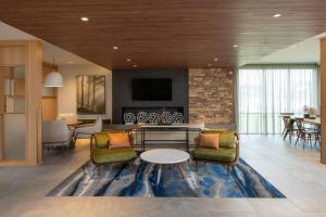 a living room with a table and chairs at Fairfield by Marriott Inn & Suites Southaven Snowden Grove in Southaven