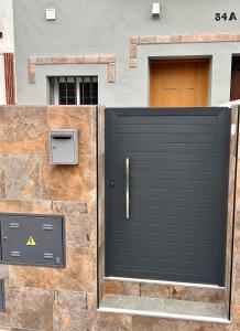 a black garage door in front of a building at Italica in Santiponce