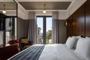 a hotel room with a bed and a large window at Hotel Afisha in Tbilisi City