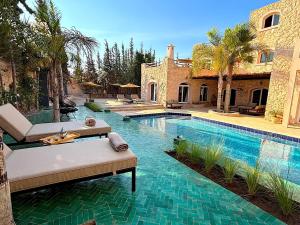 a house with a swimming pool in front of a house at Palais Babel in Essaouira