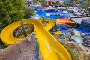 a yellow water slide at a water park at Al Habtoor Grand Resort, Autograph Collection in Dubai
