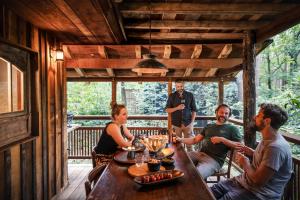 a group of people sitting around a table on a porch at Buizerd in Retie