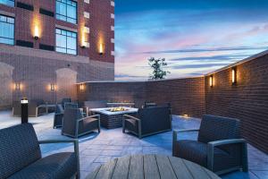 a patio with chairs and a fire pit on a building at Courtyard by Marriott Dallas Frisco in Frisco