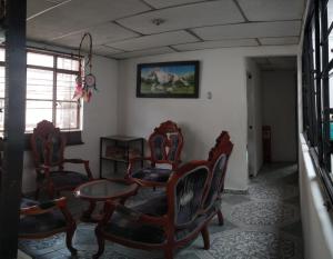 a room with chairs and a table and a picture on the wall at My second house in Manizales