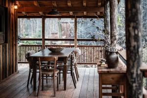 a wooden table and chairs on a wooden deck at Buizerd in Retie +12 photos