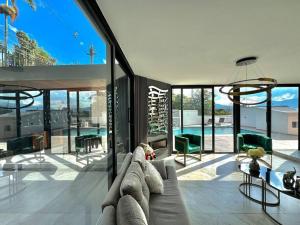 a living room with a couch and some windows at Mansión moderna Poblado-Piscina- in Medellín