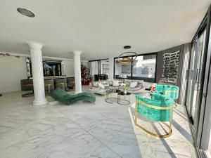 a living room with couches and a table and chairs at Mansión moderna Poblado-Piscina- in Medellín