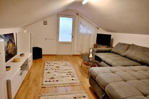 a living room with a couch and a table at Casa linistita Ilie in Păltineni