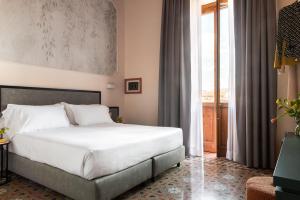 Postel nebo postele na pokoji v ubytování Hotel Fiorita