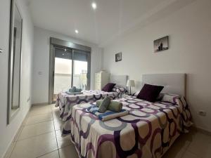 a bedroom with two beds and a window at Samsara Beach in Port d'Alcudia