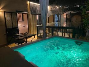 a large swimming pool in the middle of a room at Riad ART DE VIVRE avec Jacuzzi in Marrakesh