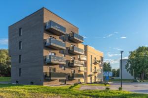 a building with balconies on the side of it at Apartment with sauna in the heart of Tartu in Tartu