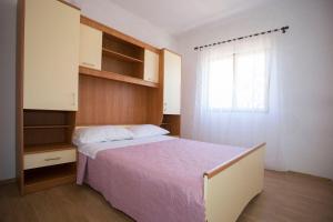 Postel nebo postele na pokoji v ubytování Apartments Ana