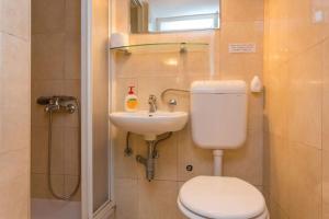 a bathroom with a toilet and a sink at House Star 1 in Dubrovnik +34 photos