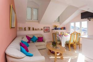 a living room with a couch and a table at House Star 1 in Dubrovnik
