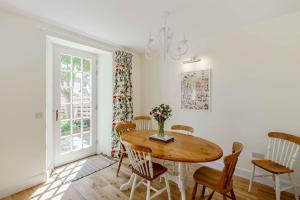 a dining room with a wooden table and chairs at Coulter Cottage in Earlsferry +22 photos
