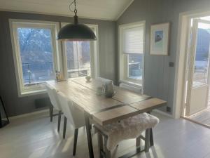 a dining room with a wooden table and chairs at Chalet with amazing fjord view in Lingåsen in Valldal