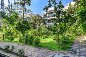a garden in front of a building at Tranquil Alibaug in Alibag