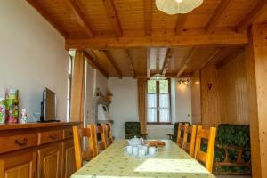 a dining room with a table and chairs and a table and chairsktop at La maison d'aurelles in Chaulhac