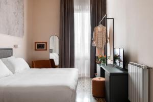 Postel nebo postele na pokoji v ubytování Hotel Fiorita