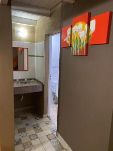 a bathroom with a sink and a mirror at Los Laureles de Sorso in Villa Ciudad Parque